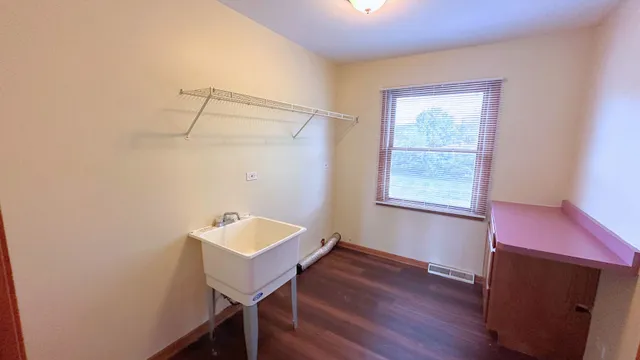 a bathroom with a sink a mirror and a window