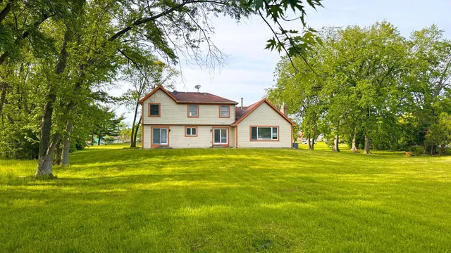 a front view of a house with a big yard