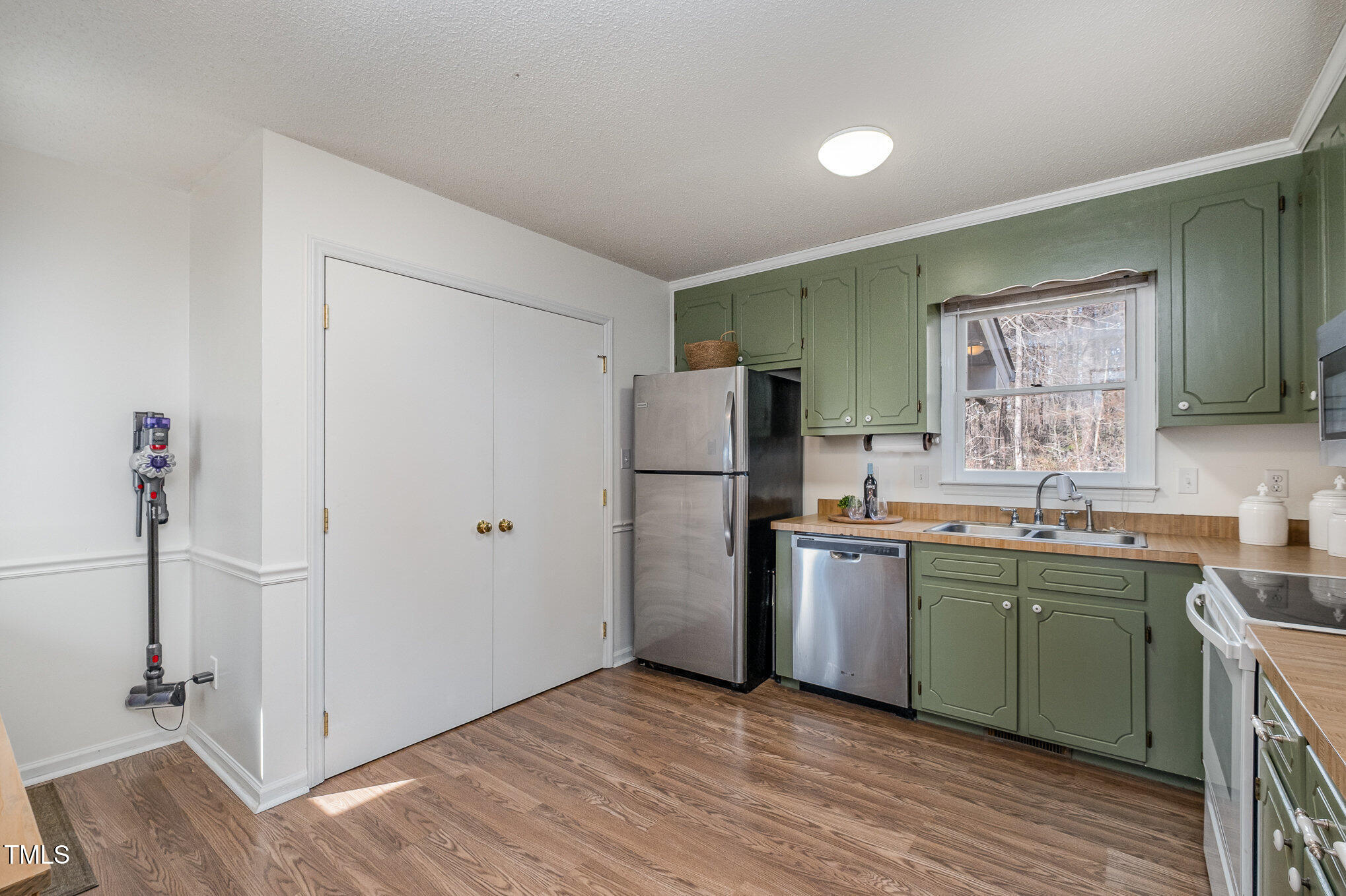 4213 Timberbrook Drive Raleigh, NC 27616 - Photo 10 of 37 a kitchen with stainless steel appliances granite countertop a refrigerator and a sink
