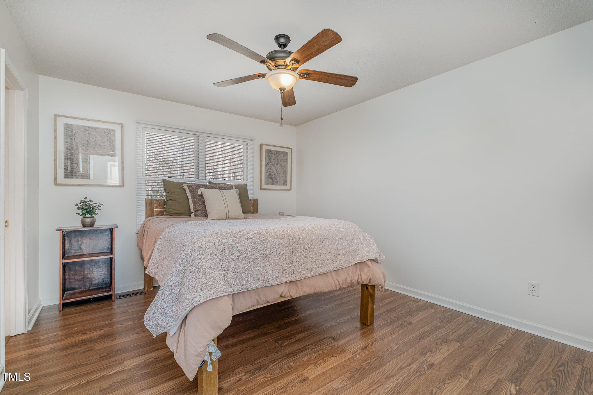 4213 Timberbrook Drive Raleigh, NC 27616 - Photo 14 of 37 a bedroom with a bed and wooden floor