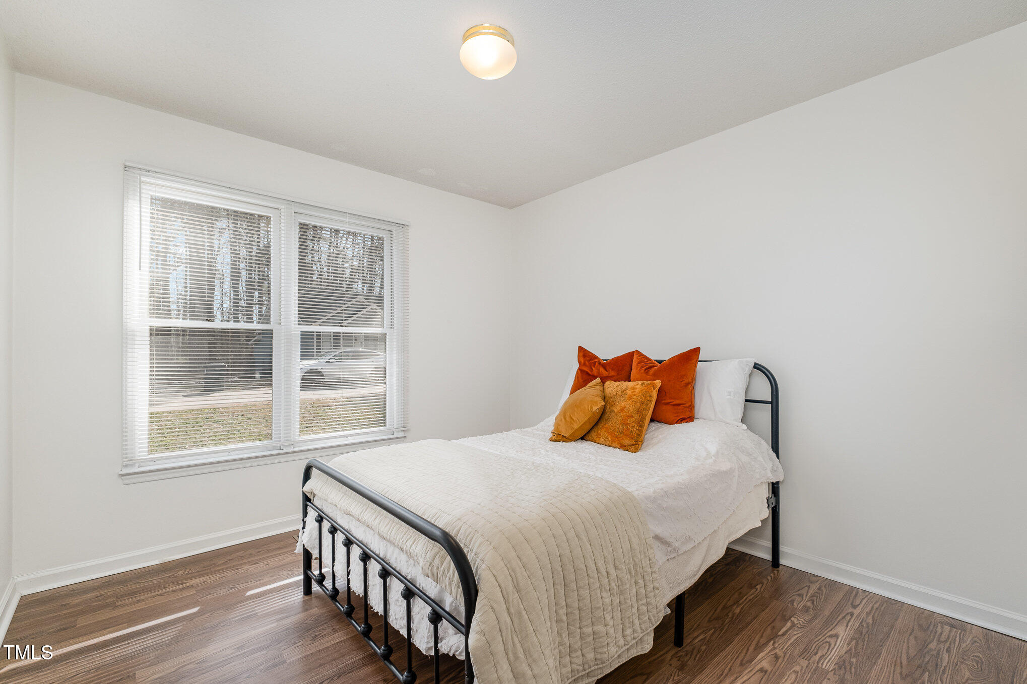 4213 Timberbrook Drive Raleigh, NC 27616 - Photo 16 of 37 a bedroom with a bed and wooden floor