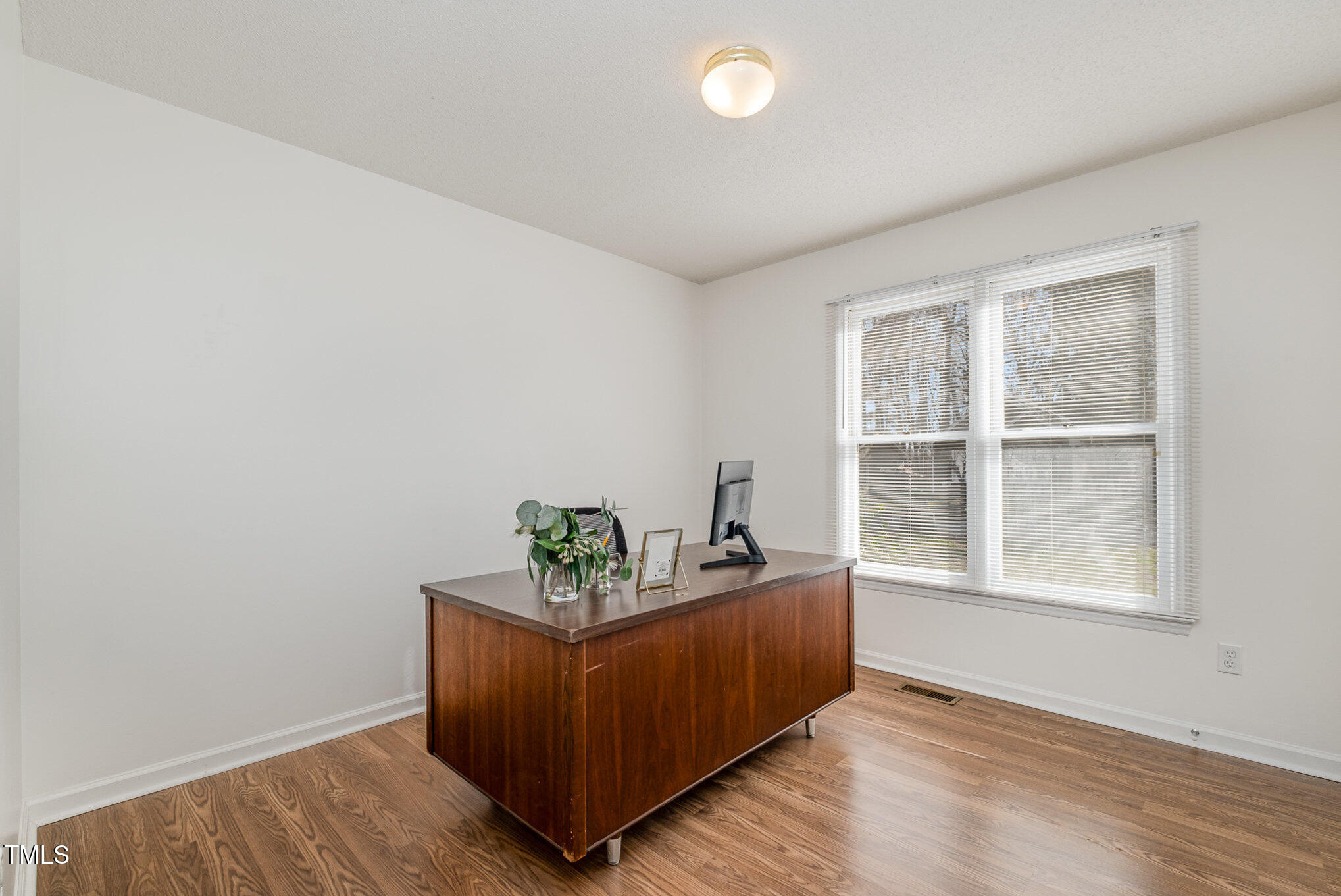 4213 Timberbrook Drive Raleigh, NC 27616 - Photo 19 of 37 an empty room with wooden floor and windows