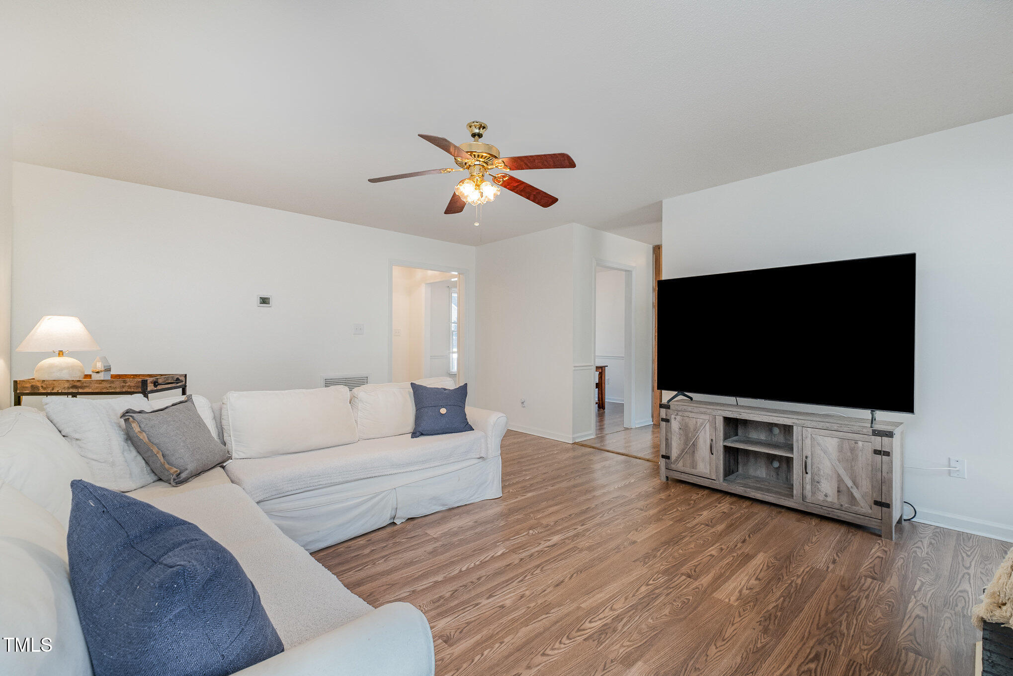 4213 Timberbrook Drive Raleigh, NC 27616 - Photo 6 of 37 a living room with furniture and a flat screen tv