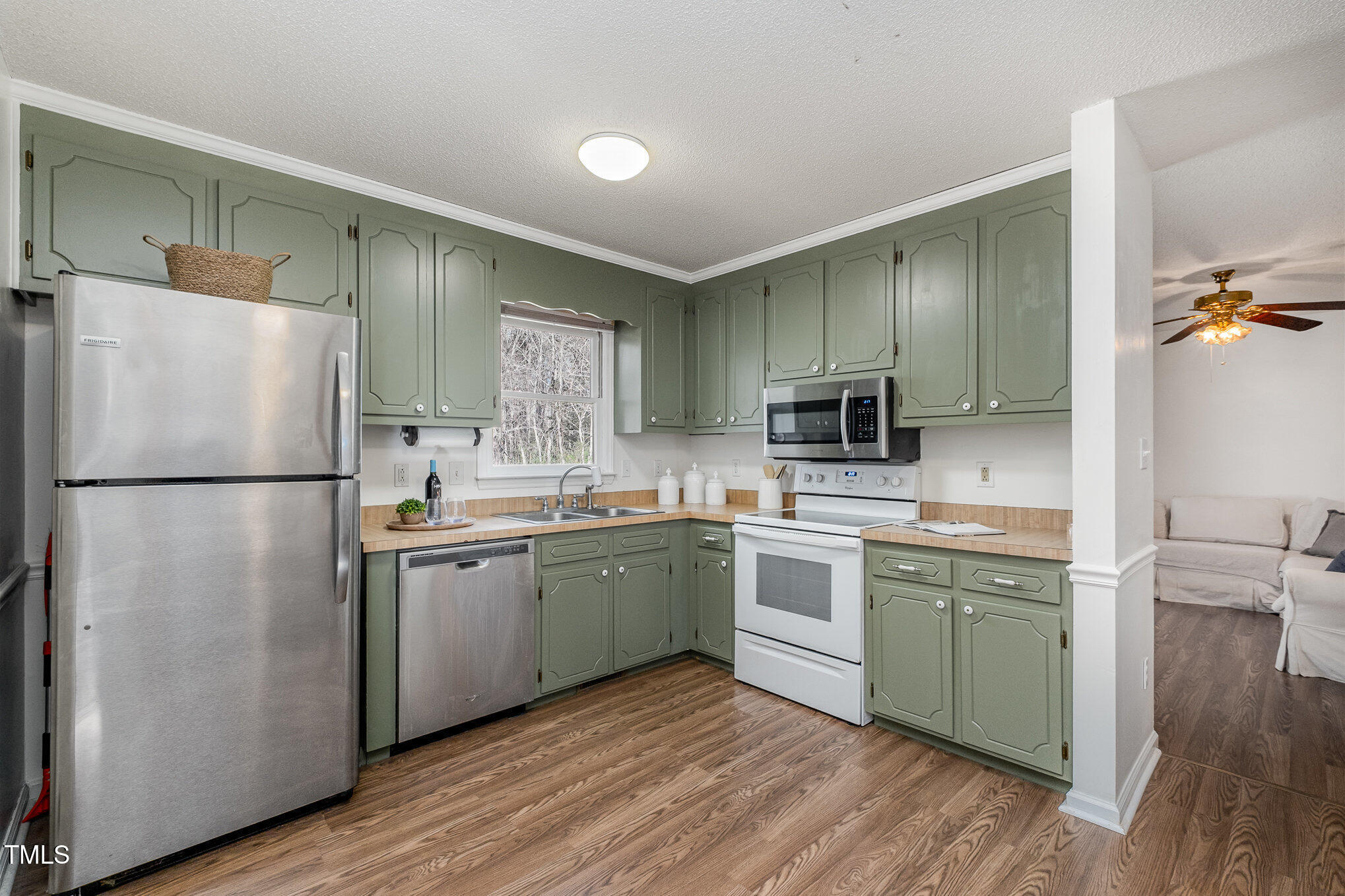 4213 Timberbrook Drive Raleigh, NC 27616 - Photo 8 of 37 a kitchen with a refrigerator a sink and cabinets