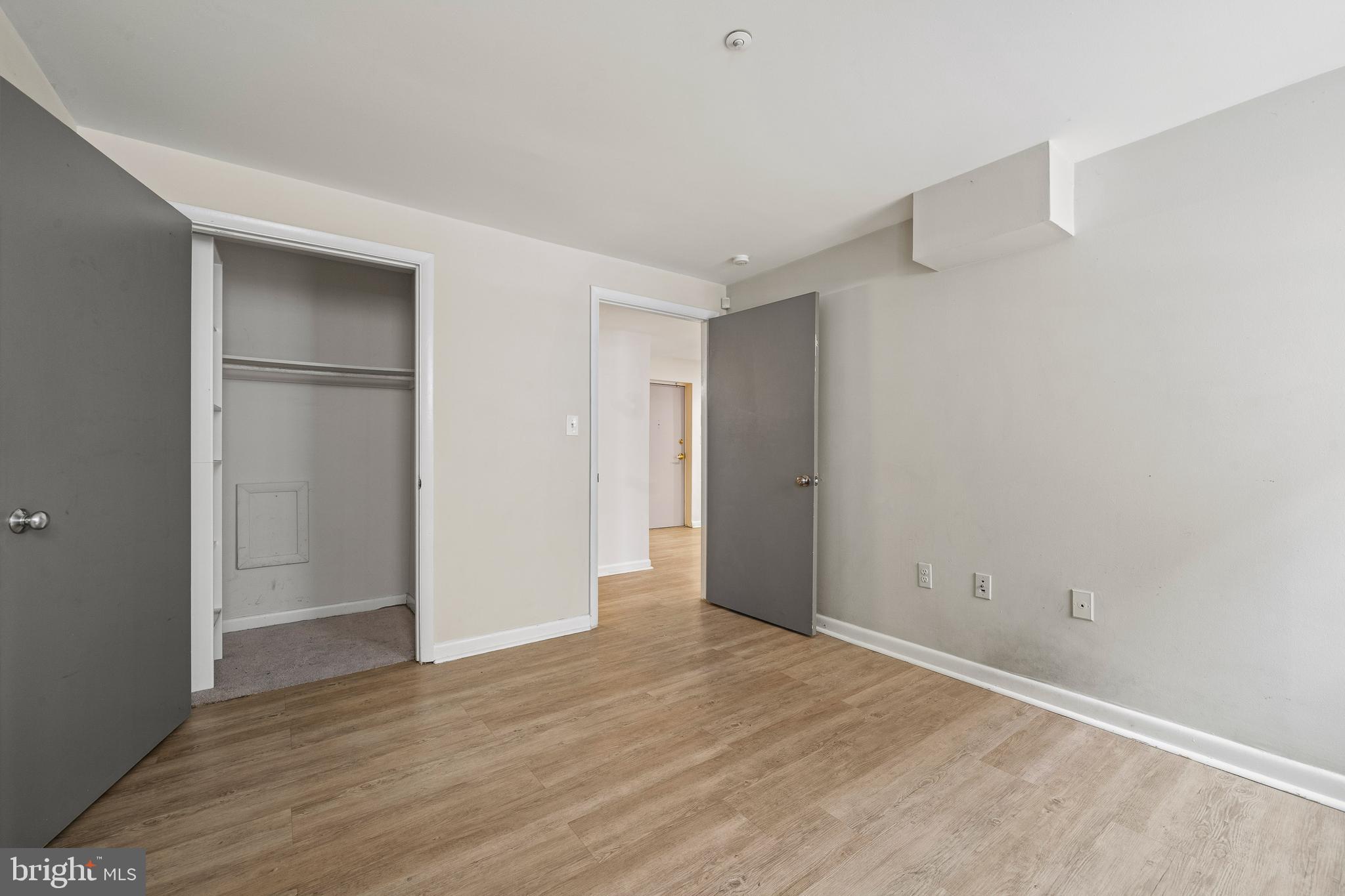 2633 Adams Mill Road Northwest, Unit B4 Washington, DC 20009 - Photo 20 of 24 a view of an empty room with wooden floor & closet area