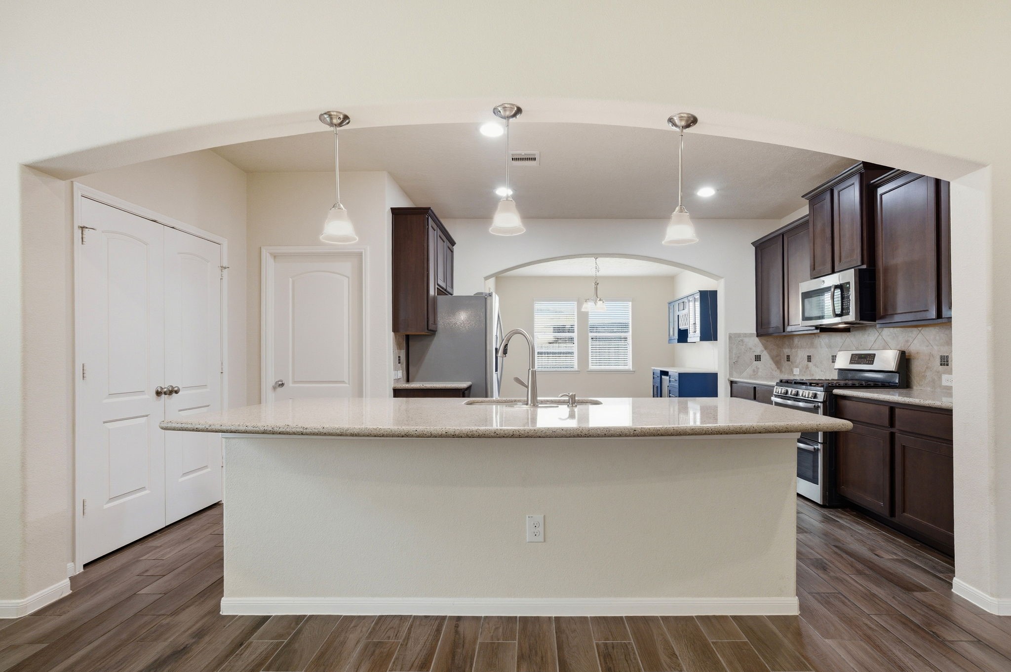 10007 Open Slope Court Humble, TX 77396 - Photo 12 of 39 a large kitchen with kitchen island a sink stainless steel appliances and cabinets