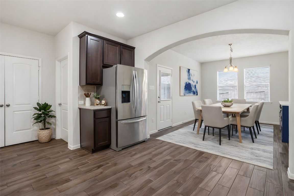 10007 Open Slope Court Humble, TX 77396 - Photo 15 of 39 a kitchen with stainless steel appliances a dining table chairs refrigerator and sink