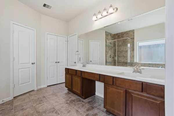a bathroom with a sink double vanity and a mirror