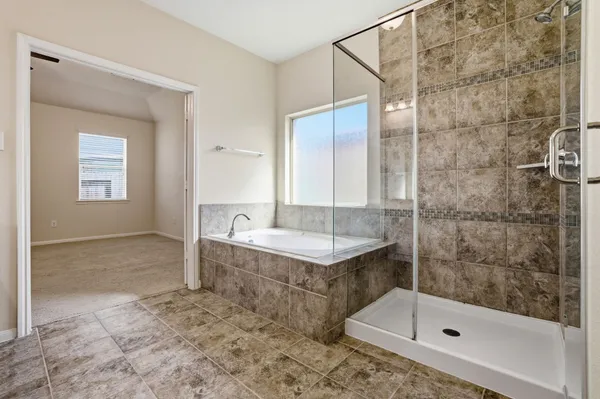 a bathroom with a shower and a sink
