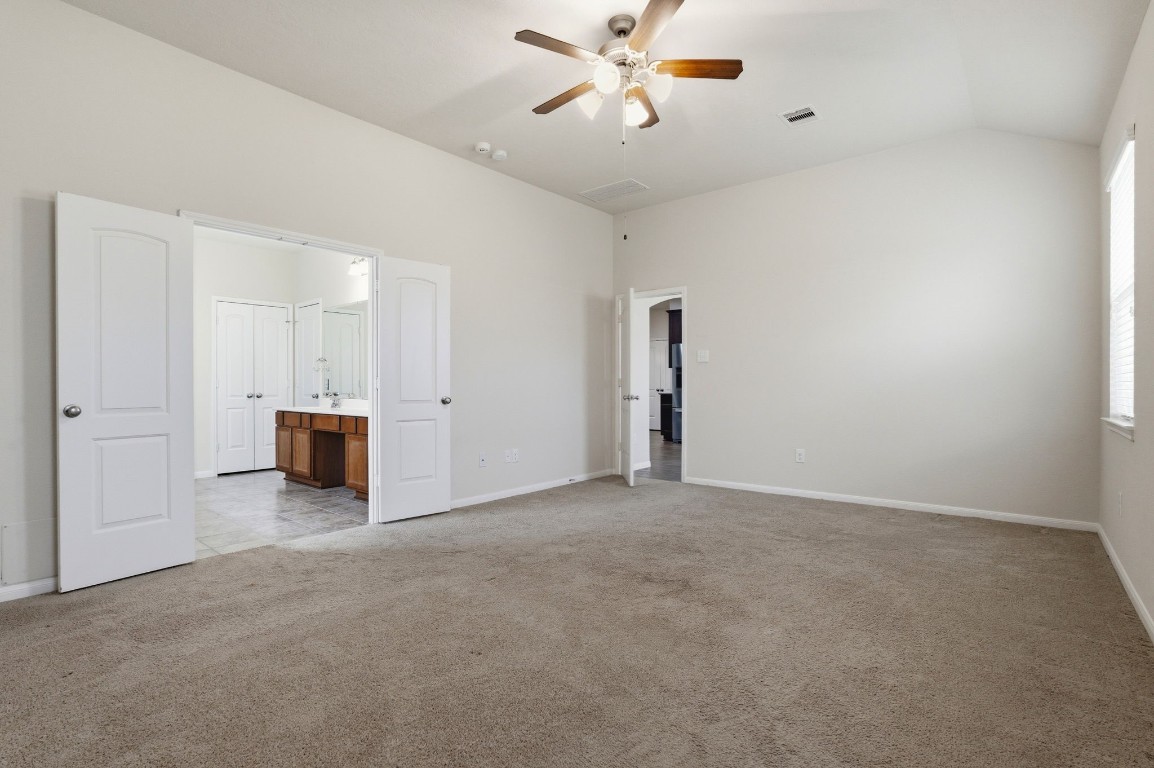 10007 Open Slope Court Humble, TX 77396 - Photo 21 of 39 a view of a livingroom with a kitchen space and a ceiling fan