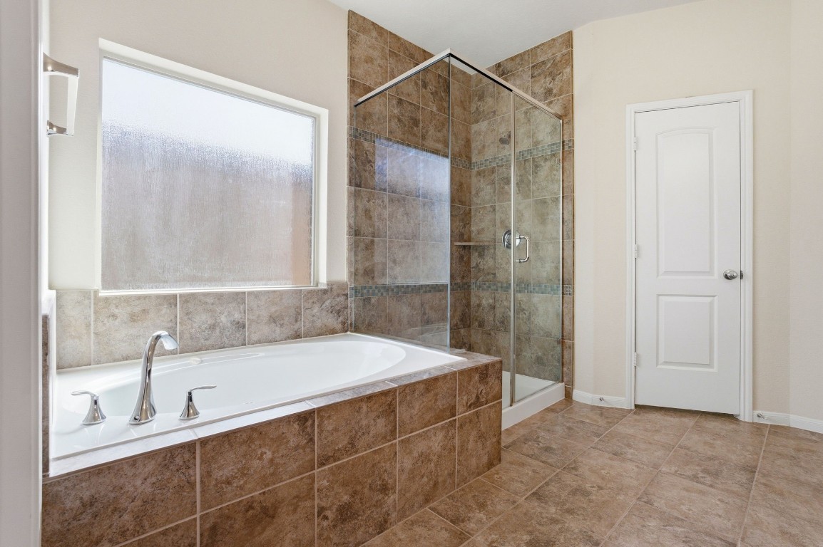 10007 Open Slope Court Humble, TX 77396 - Photo 23 of 39 a bathroom with a tub and a sink
