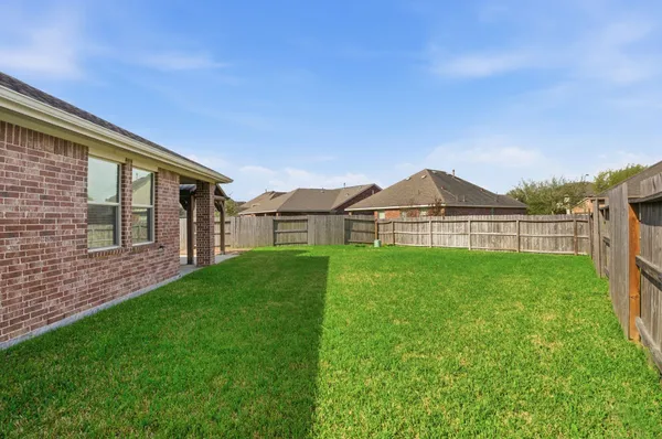 a view of a house with a yard and sitting area