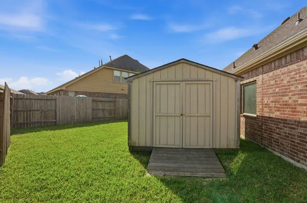 a view of a backyard with wooden fence