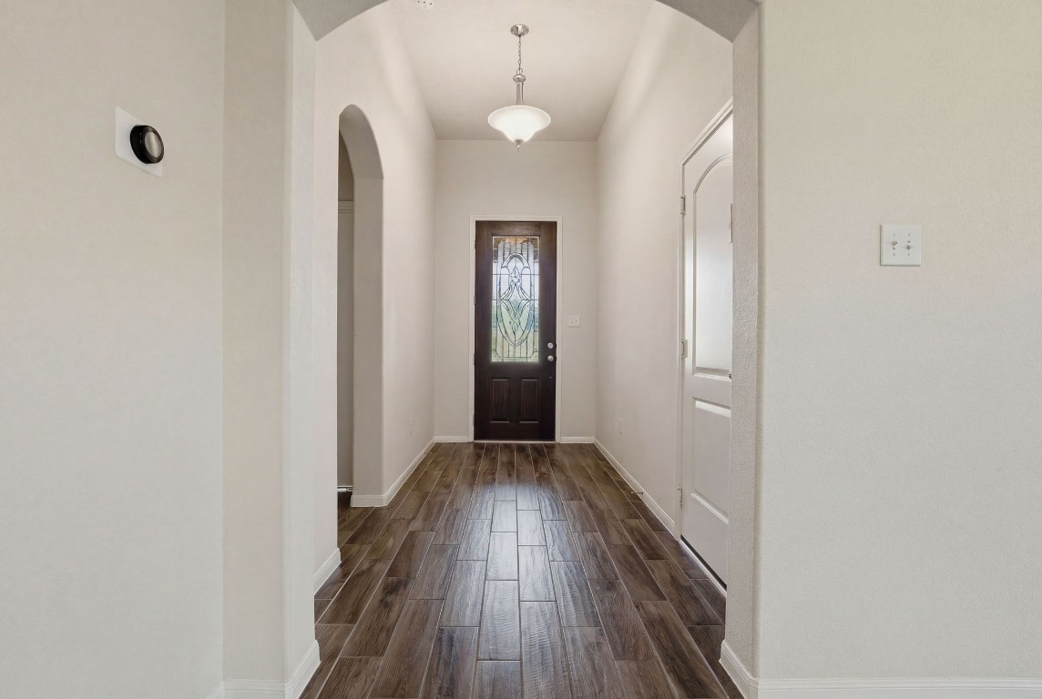 10007 Open Slope Court Humble, TX 77396 - Photo 4 of 39 a view of a hallway with wooden floor and a chandelier
