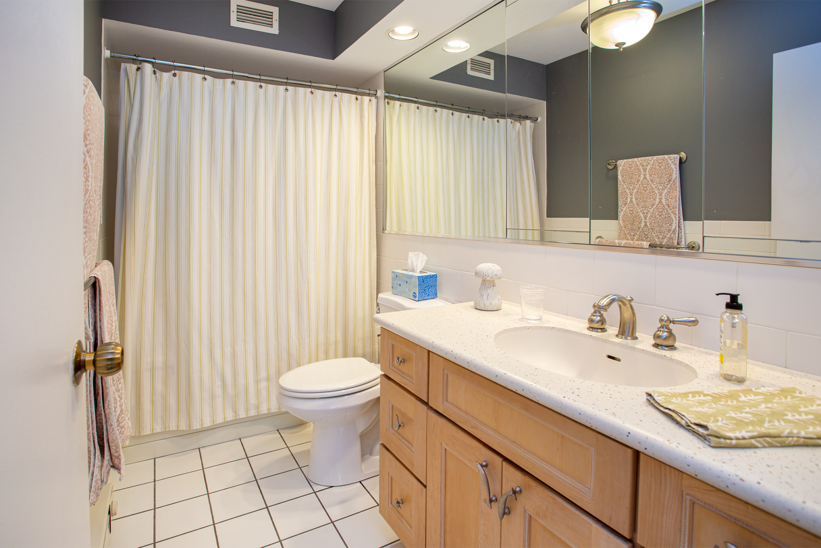 6007 North Sheridan Road, Unit 39D Chicago, IL 60660 - Photo 13 of 20 a bathroom with a granite countertop sink toilet and a mirror