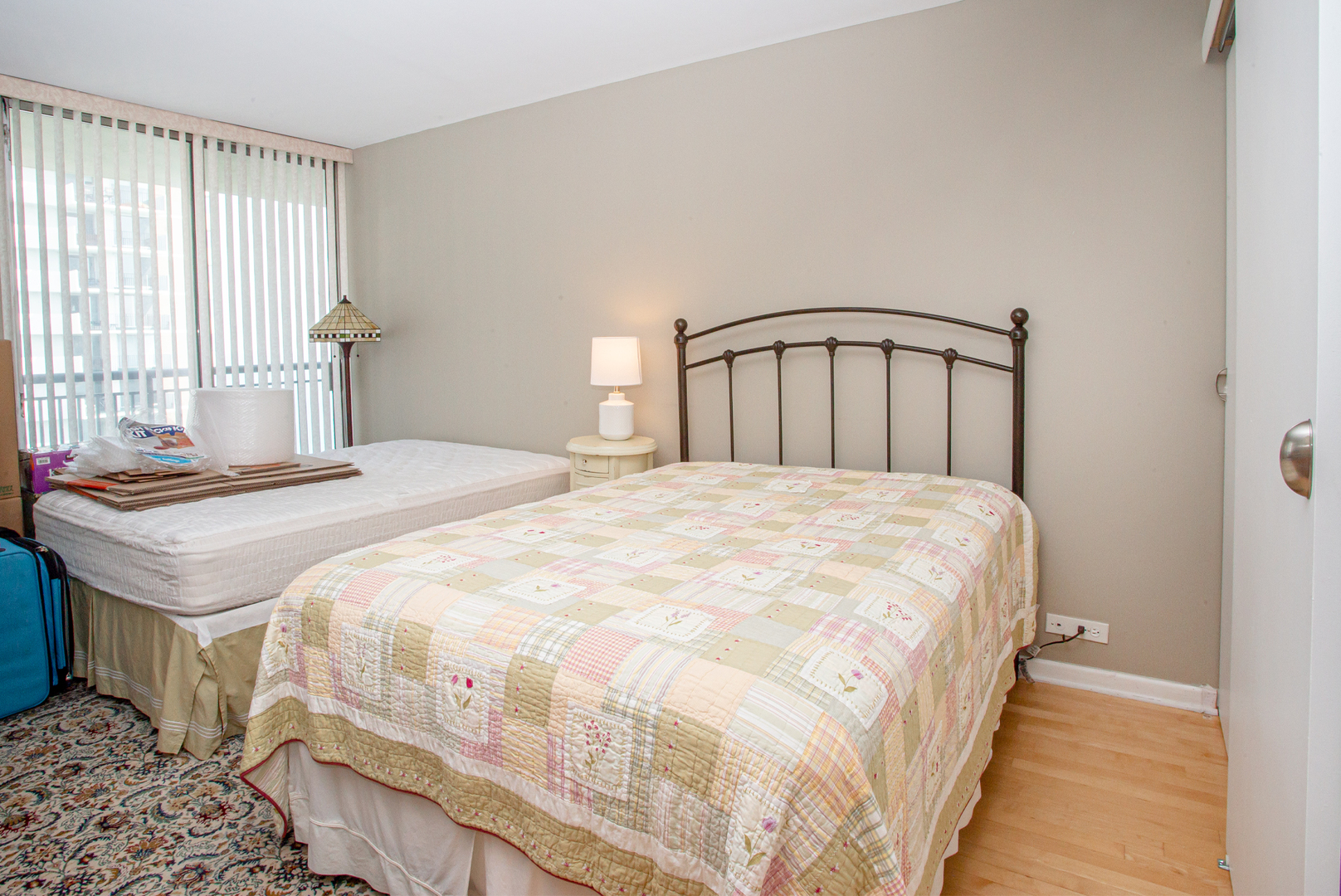 6007 North Sheridan Road, Unit 39D Chicago, IL 60660 - Photo 16 of 20 a large bed sitting in a bedroom next to a window