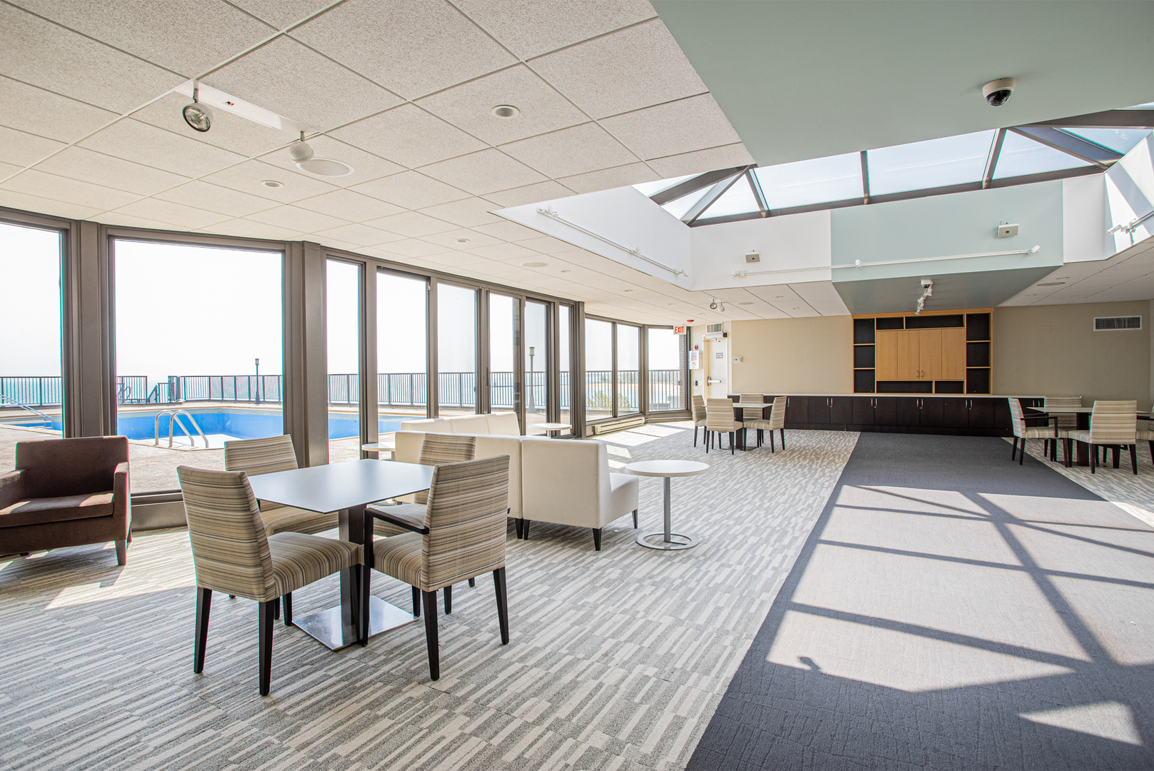 6007 North Sheridan Road, Unit 39D Chicago, IL 60660 - Photo 19 of 20 a view of a dining room with furniture large windows and wooden floor