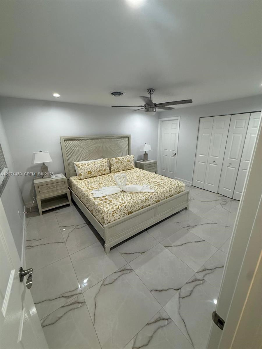 2212 Club House Road North Fort Myers, FL 33917 - Photo 16 of 40 a bedroom with a bed and a mirror
