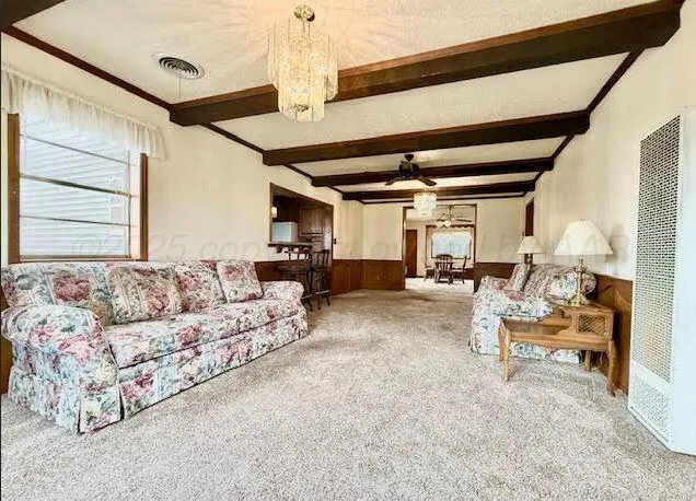 a living room with furniture and a chandelier