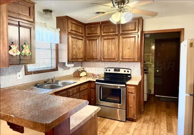 a kitchen with a stove a sink and a refrigerator