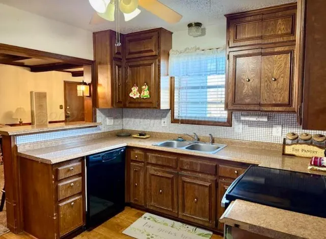 a kitchen with a sink stove and cabinets