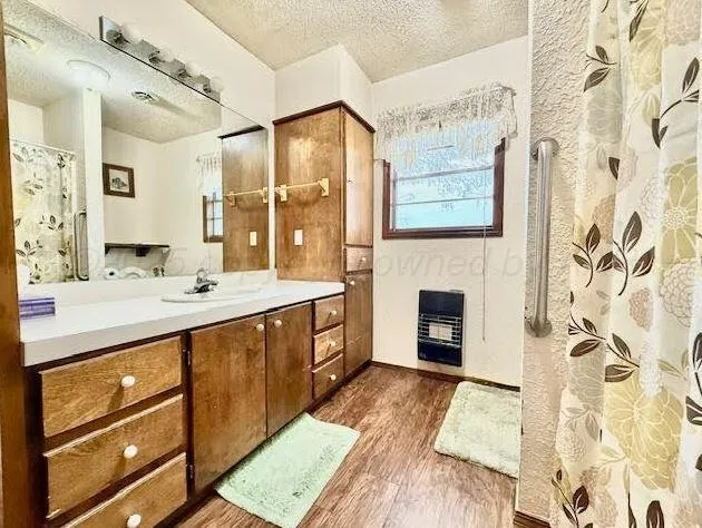 a spacious bathroom with a double vanity sink a two mirror a bathtub and a shower