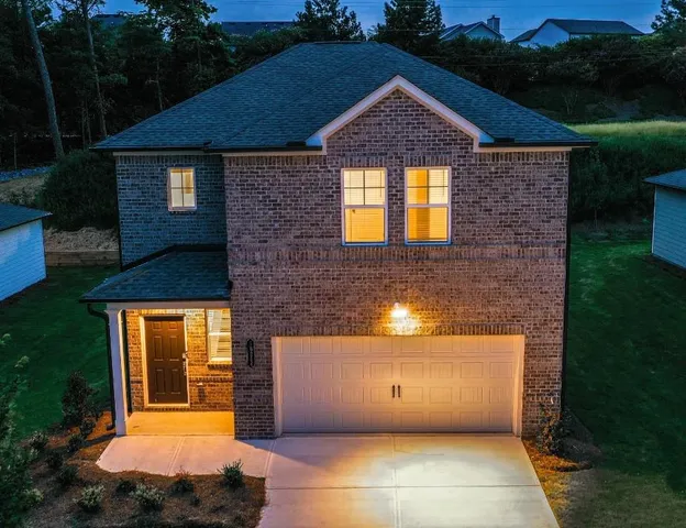 a front view of a house with a yard