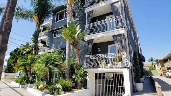 a front view of multi story residential apartment building with yard