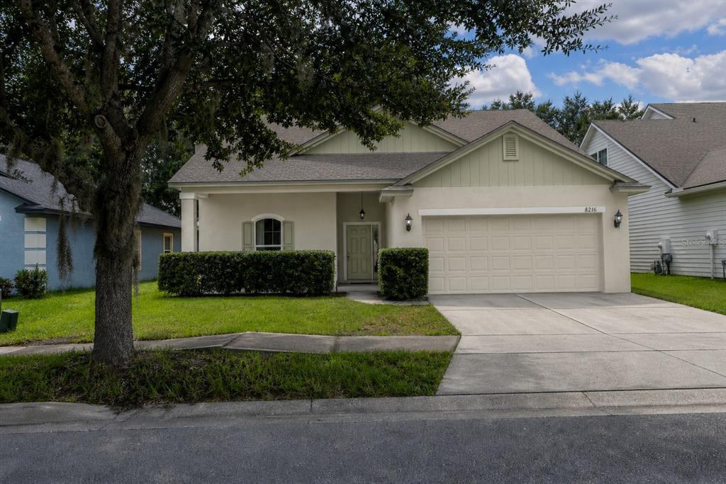 8216 Northwest 54th Street Gainesville, FL 32653 - Photo 1 of 58 a front view of a house with a yard and garage