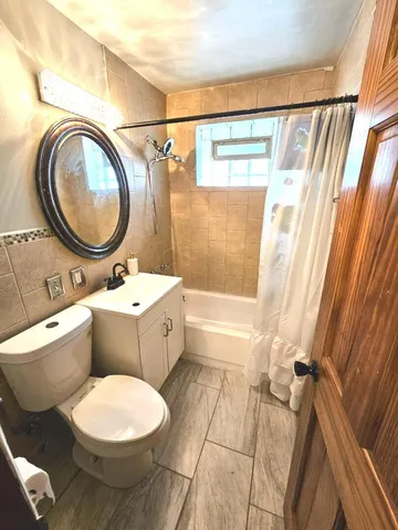 a bathroom with a toilet a sink and a mirror