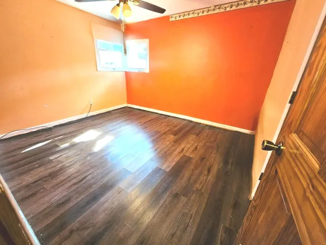a view of a room with wooden floor and small space