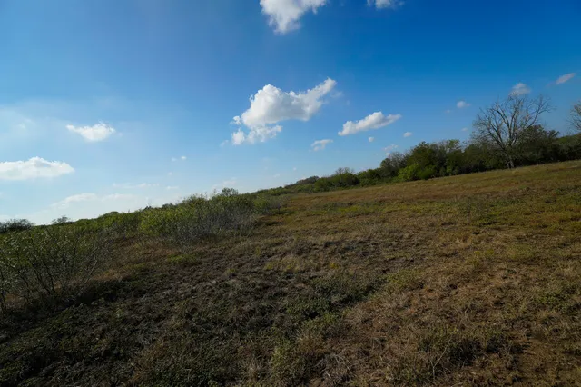 a view of mountain with sunset in background