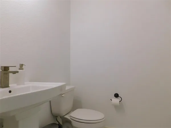 a bathroom with a sink a toilet and mirror