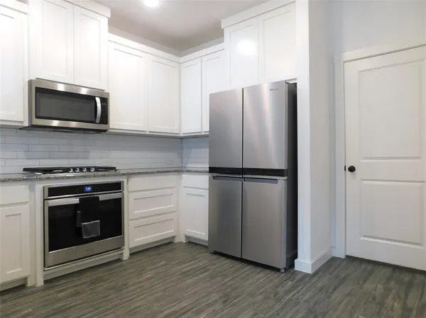 a kitchen with a refrigerator stove and microwave