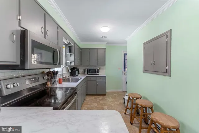 a kitchen with a sink appliances and cabinets