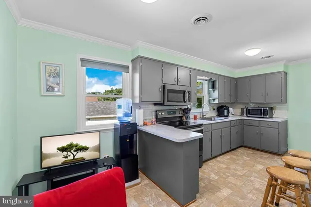 a kitchen with cabinets a sink and appliances