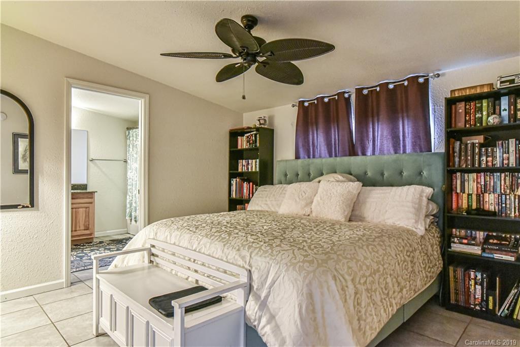 250 Mount Allen Road Black Mountain, NC 28711 - Photo 12 of 22 a bedroom with a bed and a book shelf