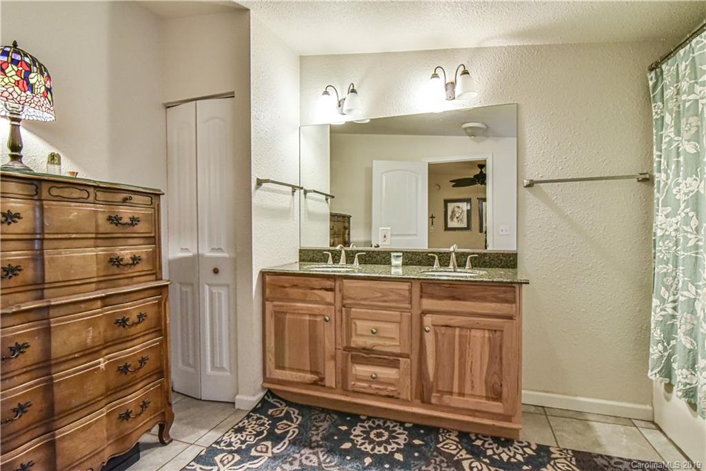 250 Mount Allen Road Black Mountain, NC 28711 - Photo 13 of 22 a bathroom with a sink a vanity and a mirror