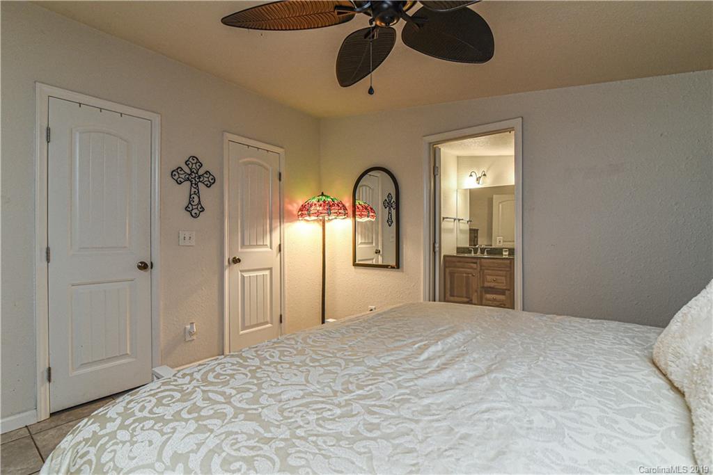 250 Mount Allen Road Black Mountain, NC 28711 - Photo 14 of 22 a bedroom with a bed and cabinets