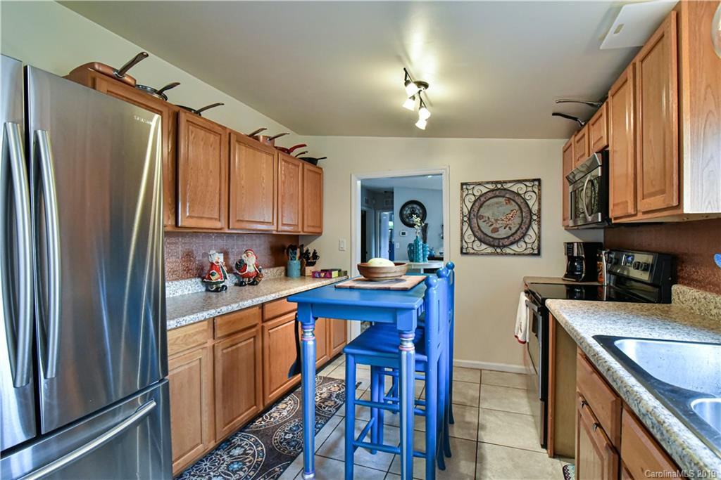 250 Mount Allen Road Black Mountain, NC 28711 - Photo 16 of 22 a kitchen with refrigerator cabinets and furniture