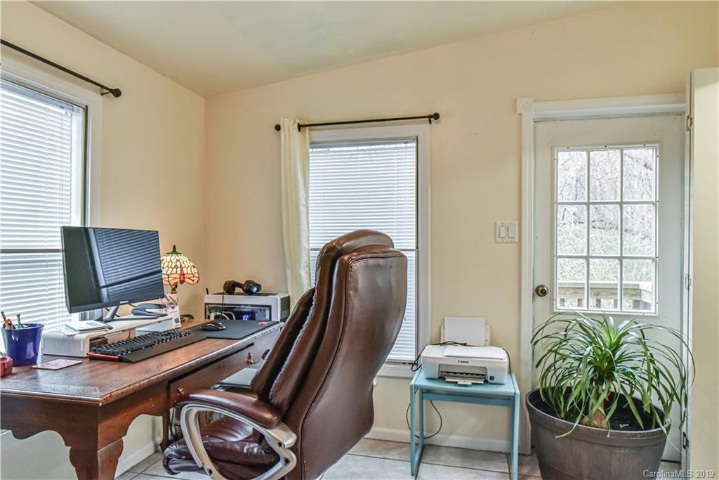 250 Mount Allen Road Black Mountain, NC 28711 - Photo 17 of 22 a view of a workspace with furniture and a window