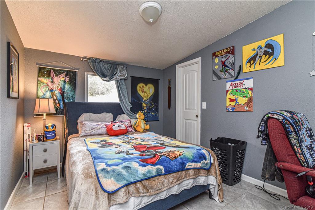 250 Mount Allen Road Black Mountain, NC 28711 - Photo 19 of 22 a bedroom that has a bed and a chair in it