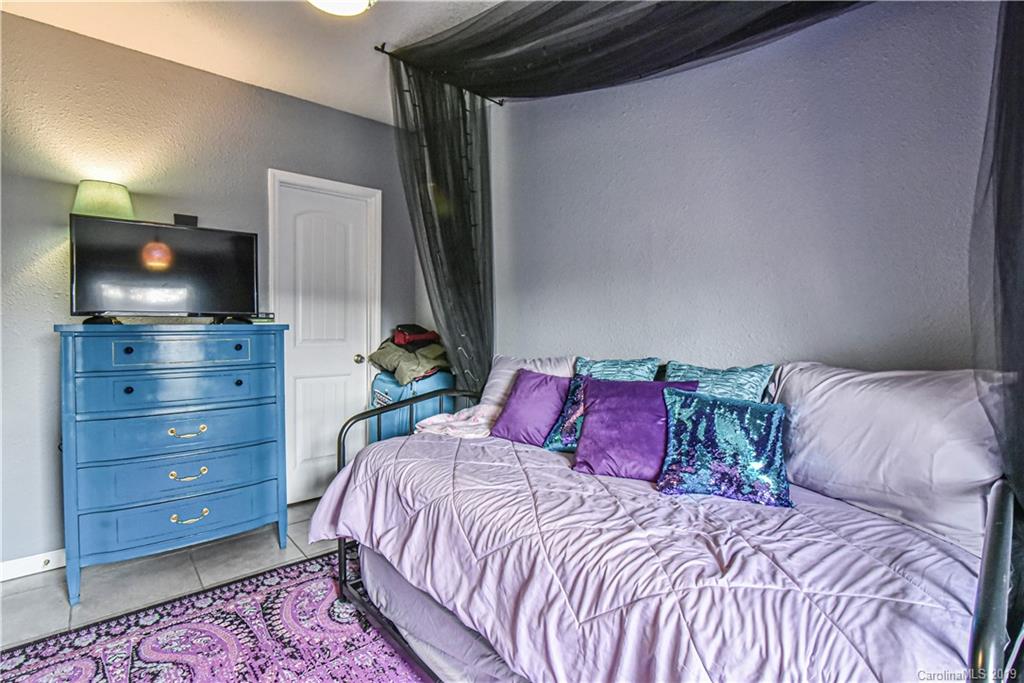 250 Mount Allen Road Black Mountain, NC 28711 - Photo 22 of 22 a bedroom with a bed and a flat screen tv