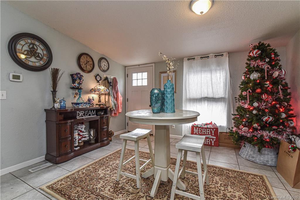 250 Mount Allen Road Black Mountain, NC 28711 - Photo 7 of 22 a living room with furniture and a clock