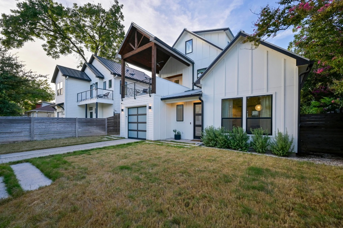 2104 East 2nd Street, Unit 1 Austin, TX 78702 - Photo 37 of 39 a front view of a house with a yard and garage