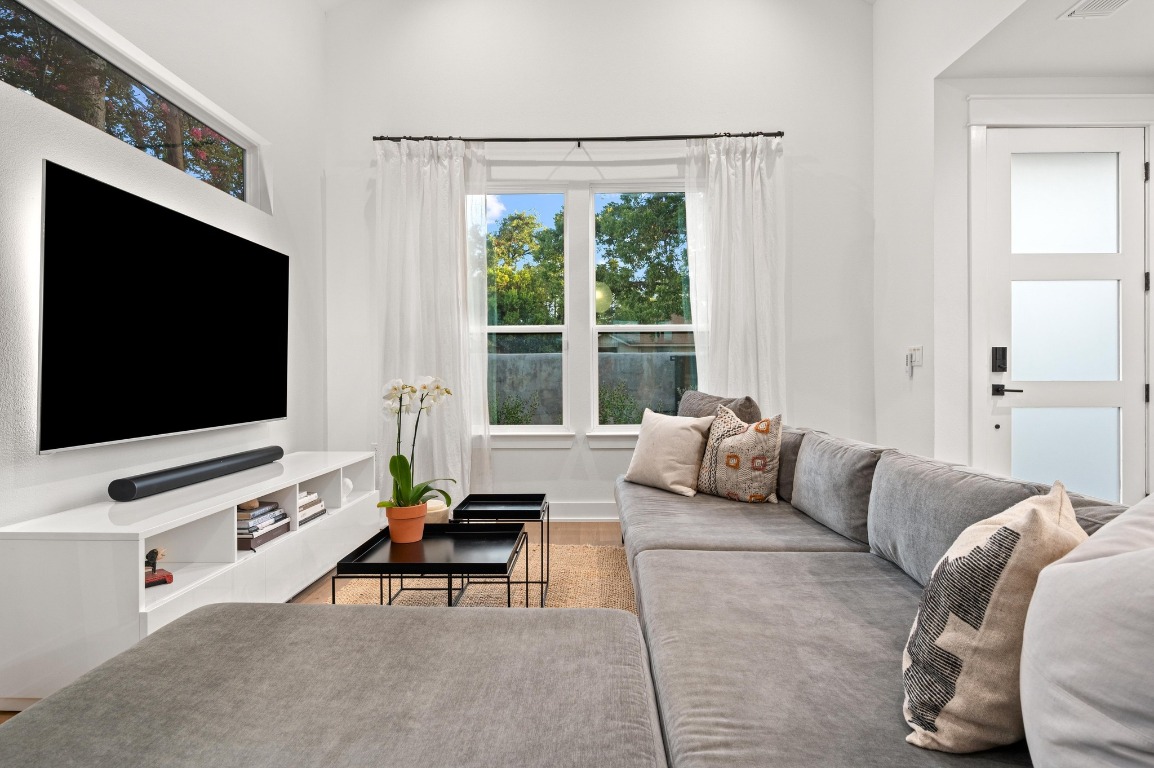 2104 East 2nd Street, Unit 1 Austin, TX 78702 - Photo 6 of 39 a living room with furniture and a flat screen tv
