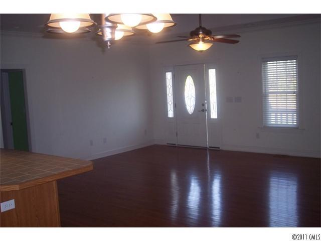 8093 Summit Ridge Drive Catawba, NC 28609 - Photo 7 of 16 a view of an empty room with wooden floor and windows