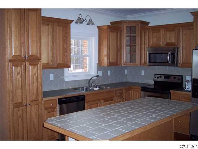 8093 Summit Ridge Drive Catawba, NC 28609 - Photo 8 of 16 a kitchen with kitchen island granite countertop a stove top oven a sink and dishwasher