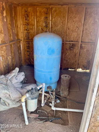 a room with water heater and wooden floor