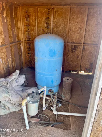 a room with water heater and wooden floor